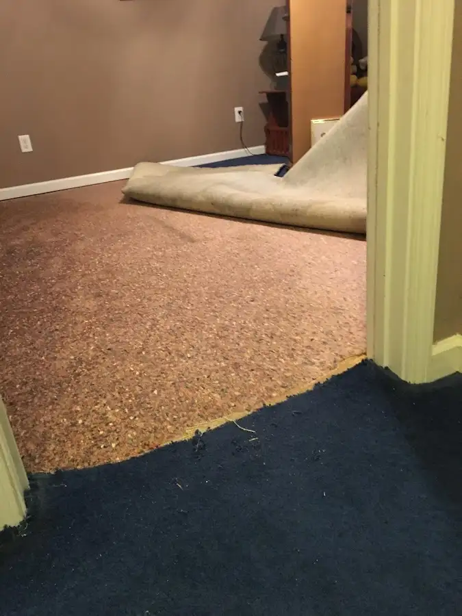Carpet pad removal revealing water damage during Water Mitigation Services in Simpsonville